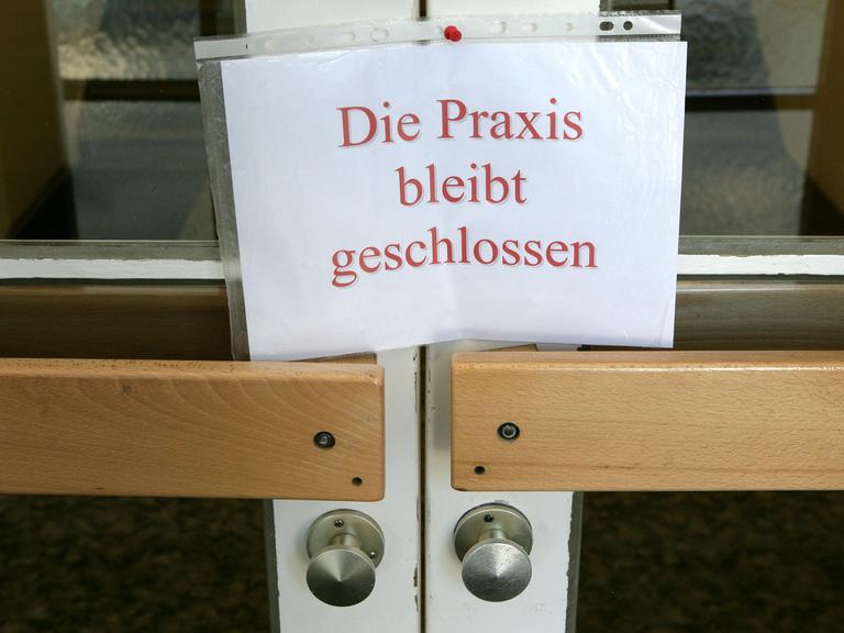 An einer Tür zu einer Arztpraxis im brandenburgischen Briesen (Oder-Spree) hängt ein Schild mit der Aufschrift "Die Praxis bleibt geschlossen" 