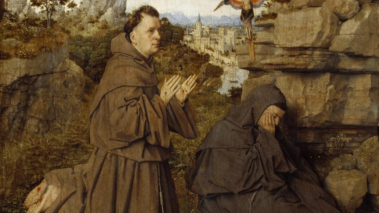 Das Bild zeigt den Heiligen Franz von Assisi in einem braunen Gewand. Im Hintergrund sind Felsen und eine Stadt zu sehen.