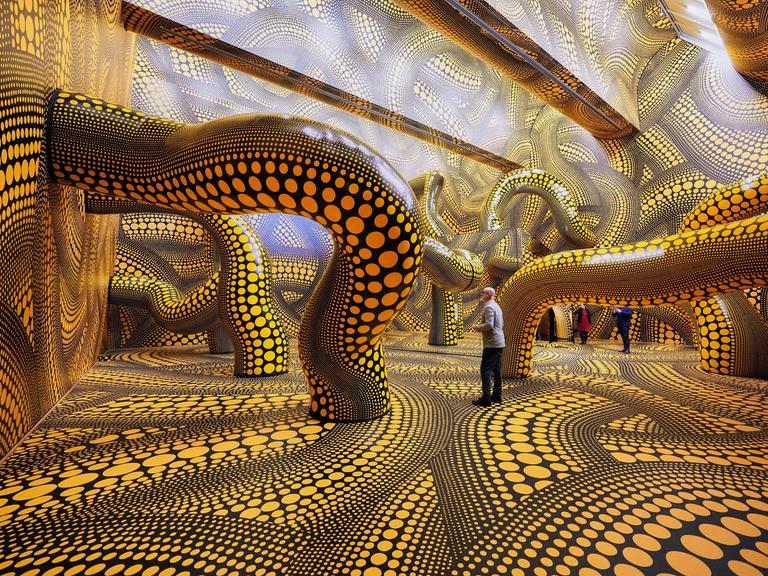 Besucher der Ausstellung im Kölner Museum Ludwig gehen durch das Werk "Infinity Mirrored Room" der legendären japanischen Künstlerin Yayoi Kusama.