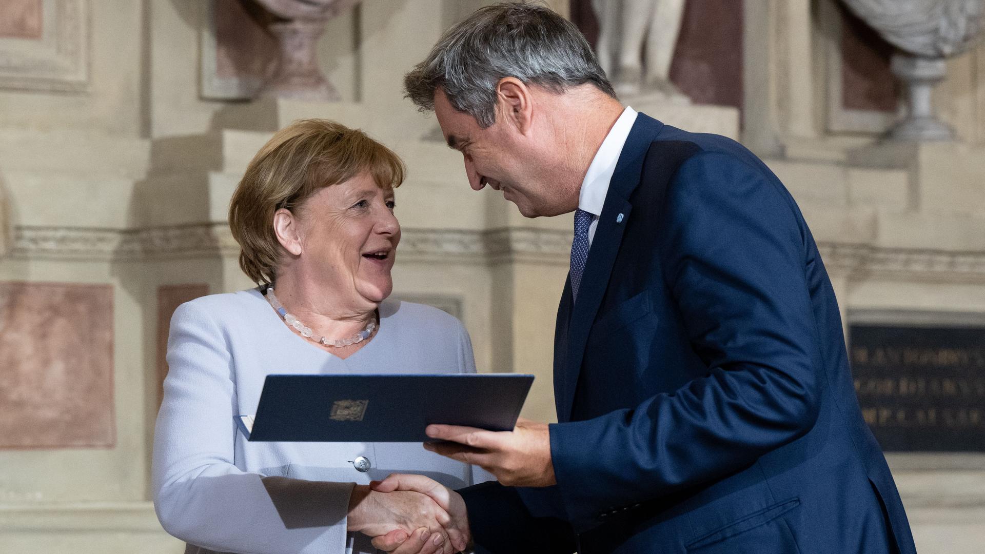 München: Markus Söder (CSU), Ministerpräsident von Bayern, verleiht Angela Merkel (CDU), frühere Bundeskanzlerin, in der Residenz den Bayerischen Verdienstorden.