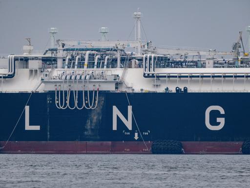 Ein Schiff hat in großen Buchstaben "LNG" auf die Bordwand geschrieben, auf dem Deck sieht man zahlreiche Röhren.