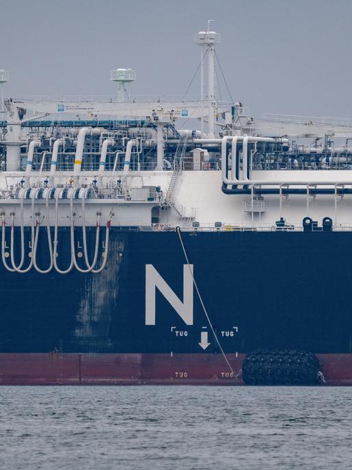 Ein Schiff hat in großen Buchstaben "LNG" auf die Bordwand geschrieben, auf dem Deck sieht man zahlreiche Röhren.