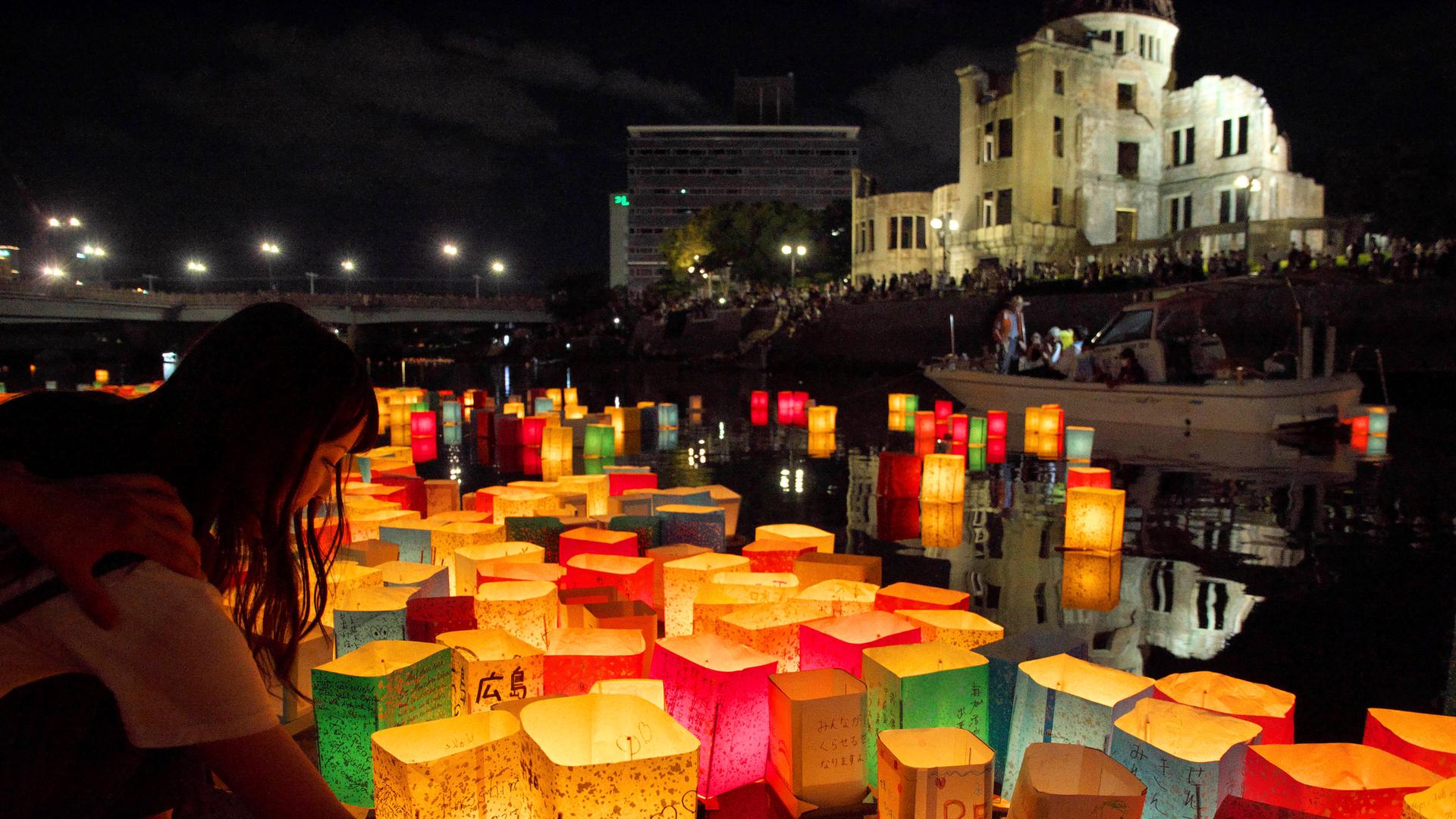 Anlässlich des 78. Jahrestages des Abwurfs der Atombombe auf Hiroshima am 06.08.2023 lassen Menschen am Friedensdenkmal in Hiroshima bunte Papierlaternen im Fluss Motoyasu schwimmen. 