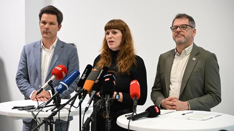 Steffen Krach, Fraktionsvorsitzender der SPD im Berliner Abgeordnetenhaus (links), Kerstin Wolter (Die Linke, Mitte) und Werner Graf, Co-Vorsitzender der Grünen-Fraktion (rechts) stehen gemeinsam an einem Tisch. Vor ihnen stehen viele Mikrofone.