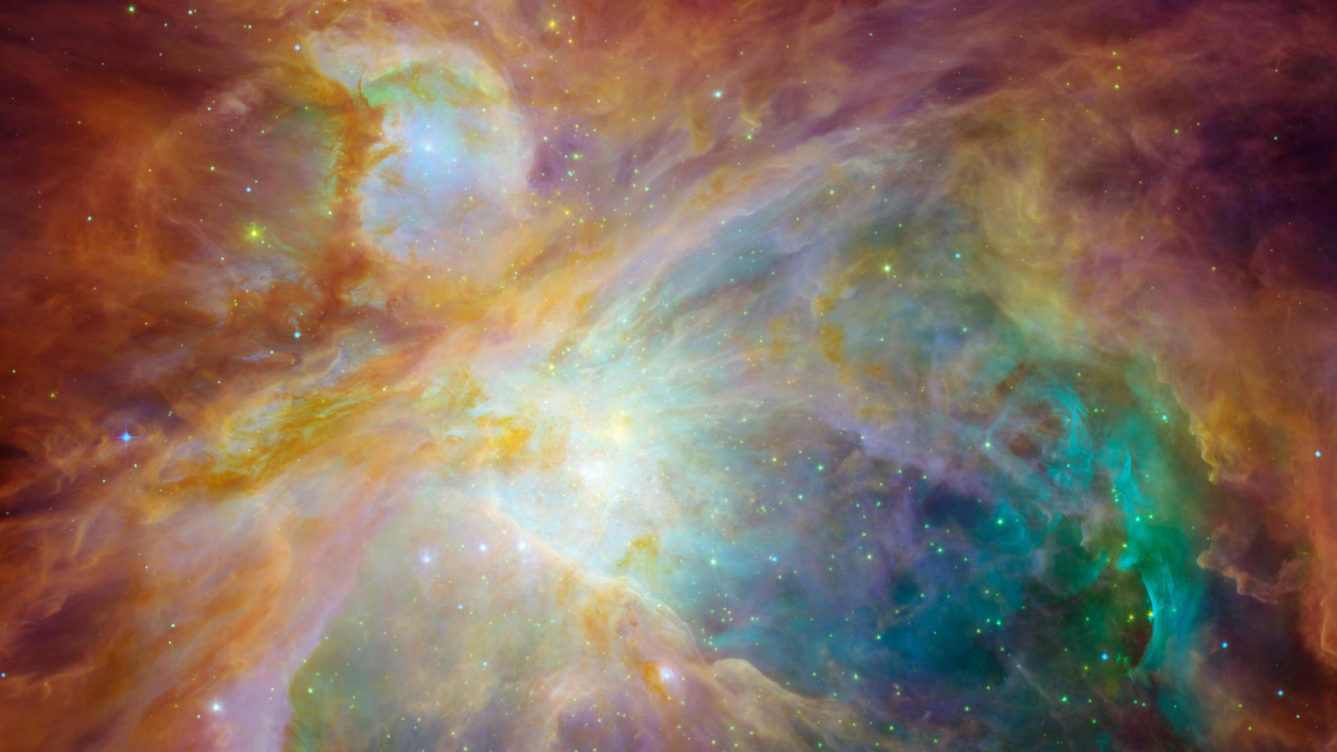Der Große Orionnebel auf einer Aufnahme des Hubble-Teleskops der NASA. Zu sehen sind violette, rote und dunkle Farbverläufe, die an Quallen erinnern. 