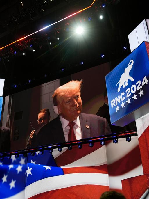 Eine große Videoleinwand zeigt Donald Trump beim Parteitag der US-Republikaner. Sein Ohr hat er mit einem großen weißen Pflaster bandagiert.