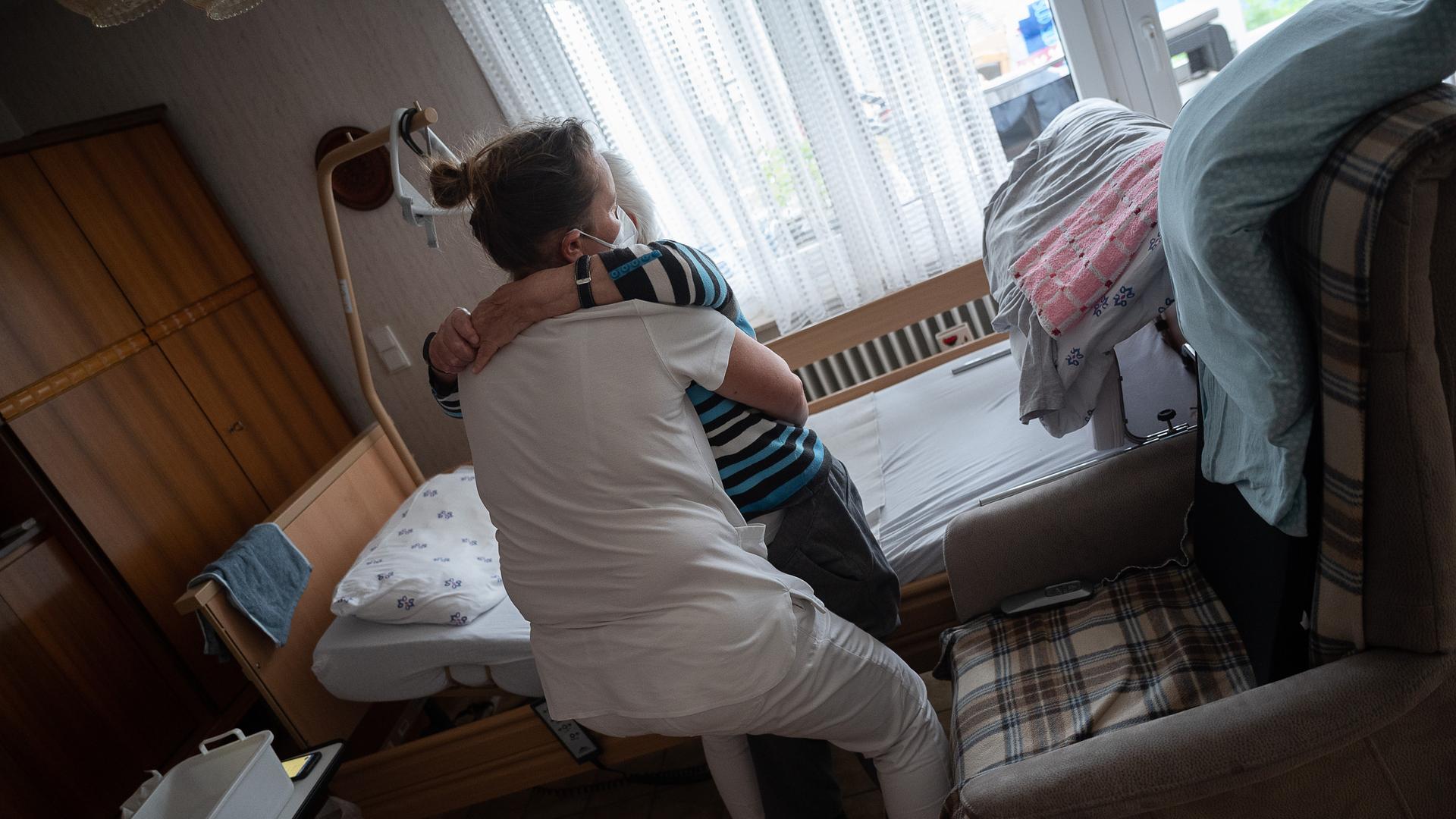 Anna Hahn (vorne), Pflegefachkraft, setzt während ihrer Schicht in der ambulanten Pflege eine Klientin vom Bett auf den Sessel. Am 12. Mai ist der Tag der Pflege.