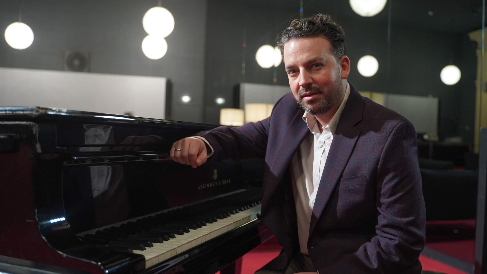 Berlin: James Gaffigan, neuer Generalmusikdirektor der Komischen Oper, sitzt an einem Klavier. Gaffigan wird mit Beginn der Spielzeit 2023/24 seine neue Aufgabe übernehmen.