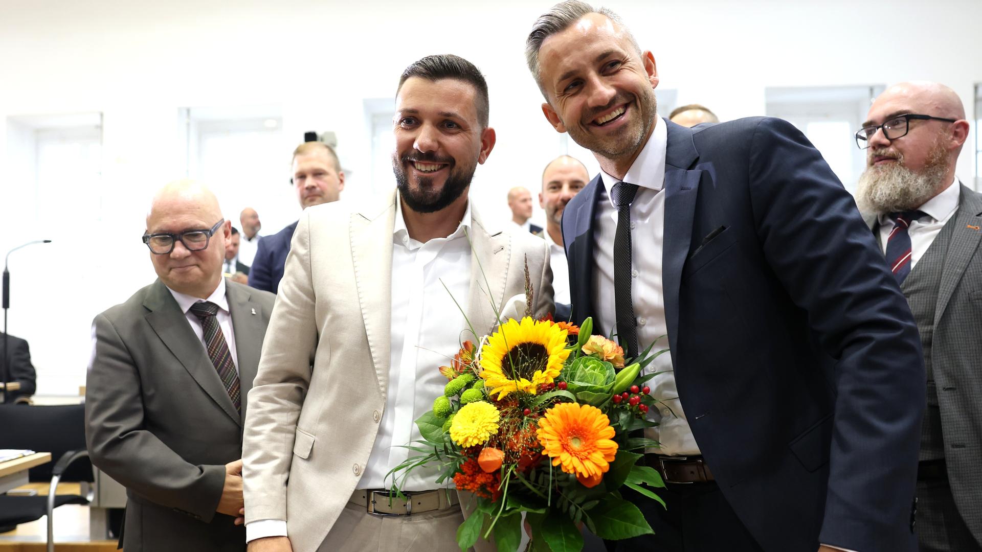 AfD-Spitzenvertreter gratulieren Tobias Rausch zur Wahl zum Landtagspräsidenten während der konstituierenden Sitzung des Landtags von Sachsen-Anhalt. Rausch und Siegmund (Mitte) halten einen gelben Blumenstrauß. AfD-Spitzenvertreter gratulieren Tobias Rausch zur Wahl zum Landtagspräsidenten während der konstituierenden Sitzung des Landtags von Sachsen-Anhalt. Rausch und Siegmund (Mitte) halten einen gelben Blumenstrauß.