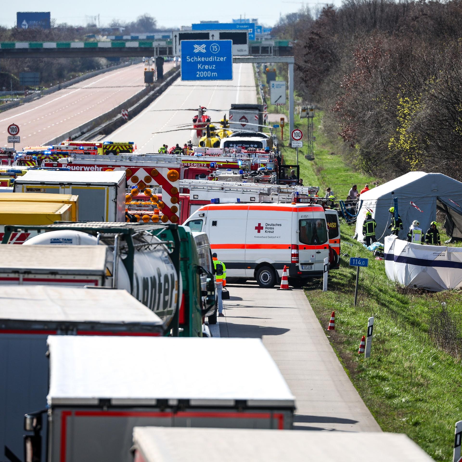 Schkeuditz: Einsatzfahrzeuge und Rettungshubschrauber stehen auf der A9 an der Unfallstelle.