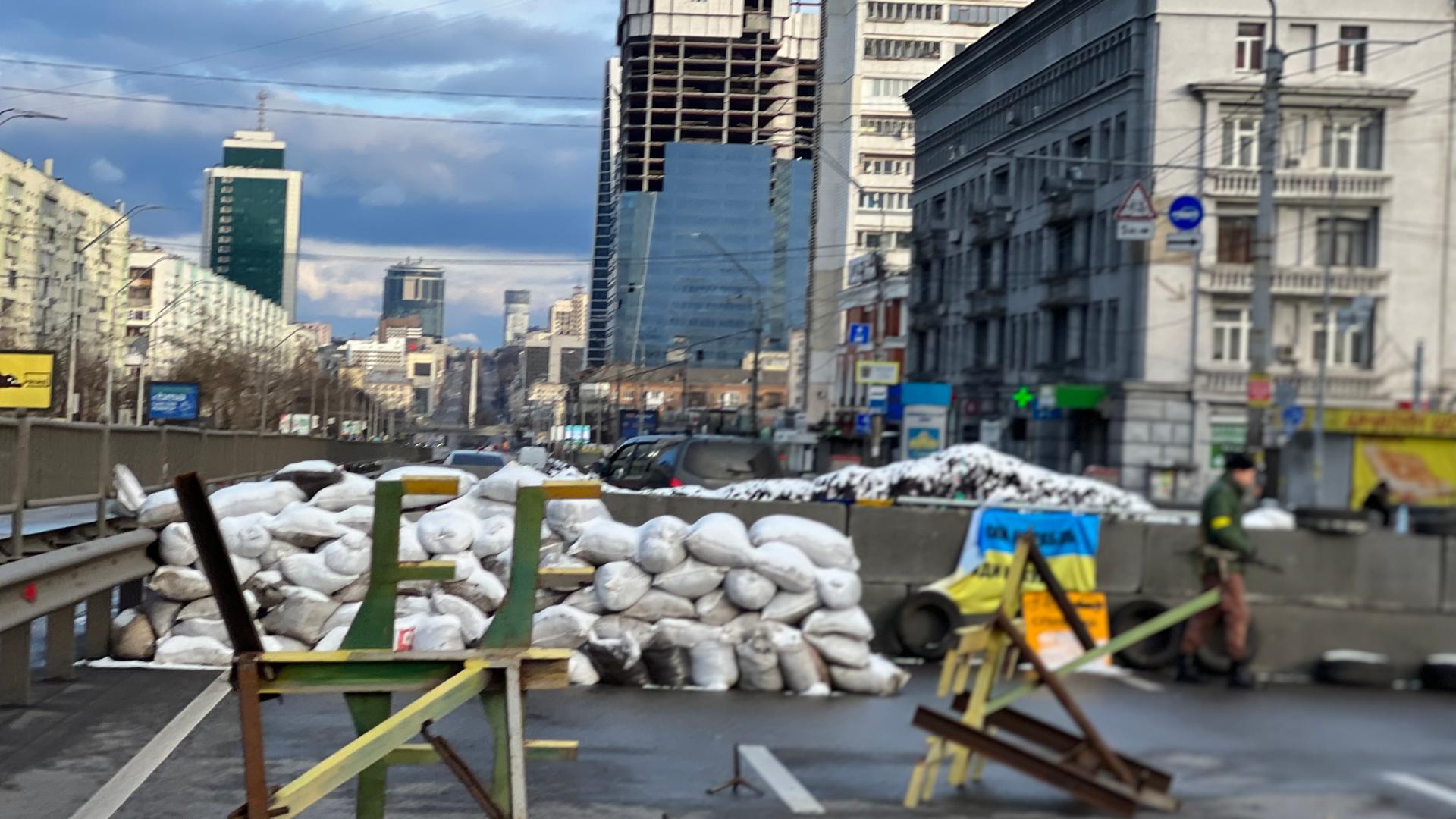 Das Bild zeigt die ukrainische Hauptstadt Kiew. Sandsäcke stehen vor einer kleinen Mauer, im Hintergrund sind Hochhäuser zu sehen Das Bild zeigt die ukrainische Hauptstadt Kiew. Sandsäcke stehen vor einer kleinen Mauer, im Hintergrund sind Hochhäuser zu sehen