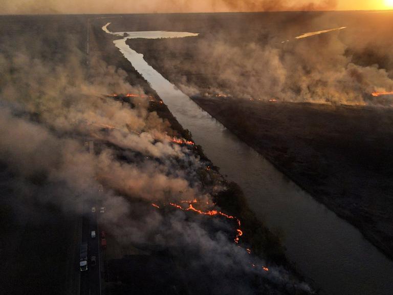 A wildfire consumes an area near Victoria, Entre Rios province, Argentina, on Aug. 19, 2022. (AP Photo/Natacha Pisarenko)