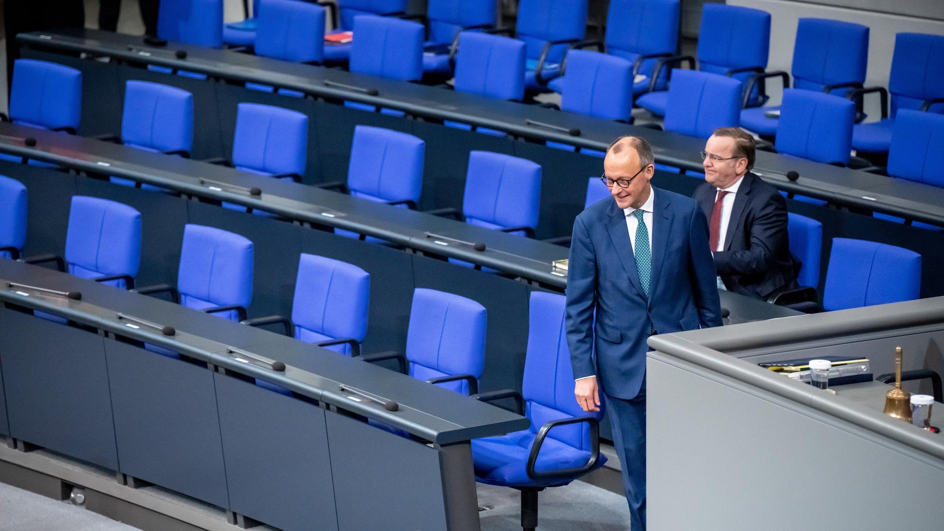 Friedrich Merz geht nach einem Gespräch mit Boris Pistorius an der Regierungsbank des Bundestages vorbei. Friedrich Merz geht nach einem Gespräch mit Boris Pistorius an der Regierungsbank des Bundestages vorbei.