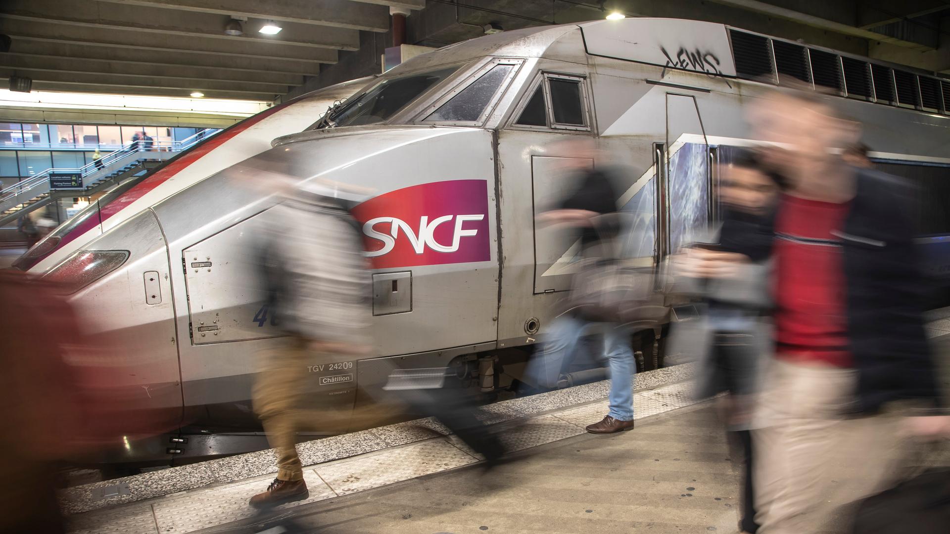 Reisende kommen mit einem SNCF Zug während eines Verkehrsstreiks am Bahnhof Montparnasse an.