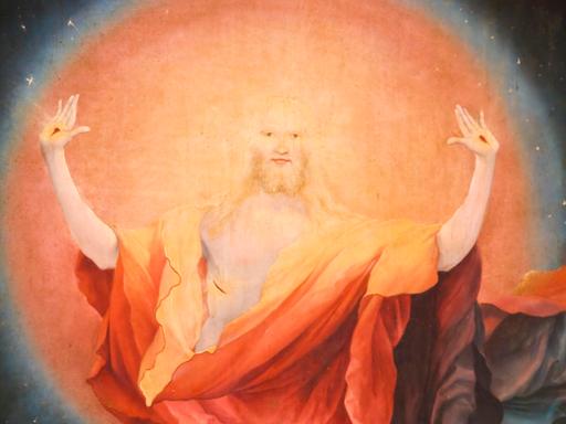 "Die Auferstehung Christi", Detail aus dem Altarbild von Matthias Grünewald in Colmar in Frankreich. Jesus streckt seine Arme aus vor hellem orangefarbenem Licht.