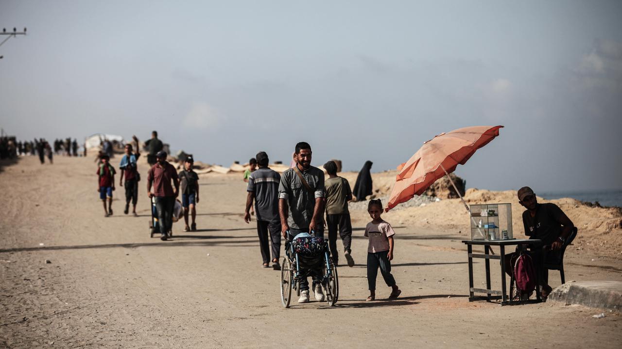 Palästinenser sind zu Fuß unterwegs in Gaza City im Gazastreifen. Palästinenser sind zu Fuß unterwegs in Gaza City im Gazastreifen.