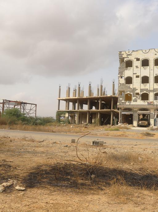 Mitglieder der jemenitischen Armee in der Stadt Harad in der Provinz Hajjah. Im Hintergrund ein zerstörtes Gebäude