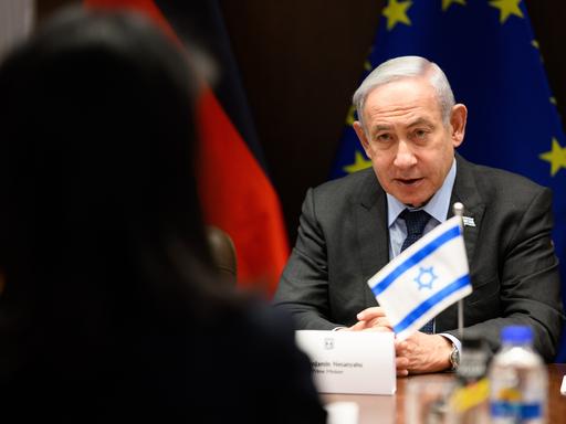 Annalena Baerbock und Benjamin Netanjahu sitzen sich gegenüber und sprechen.