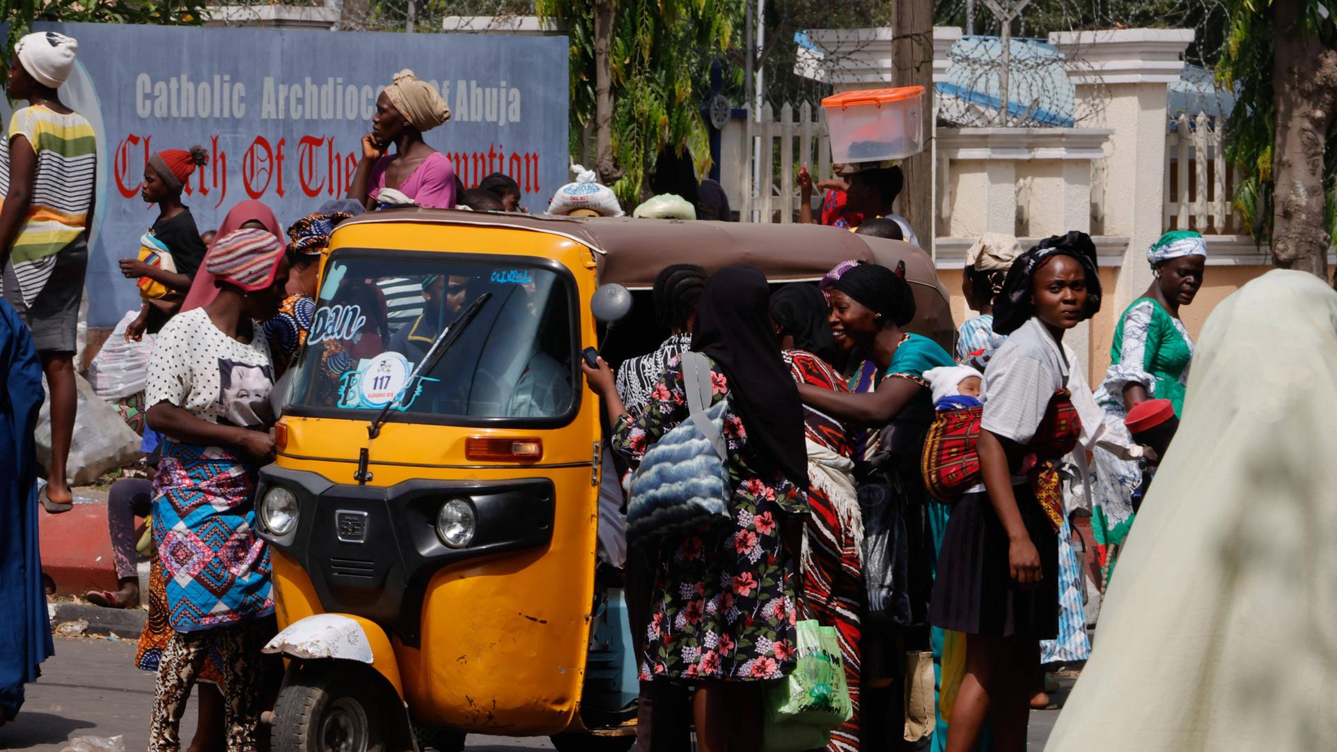 Das Foto zeigt Menschen vor einer katholischen Kirche in der nigerianischen Hauptstadt Abuja, die auf die Verteilung von Lebensmitteln warten.