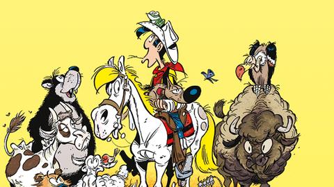 Eine Comic-Figur, der Cowboy Lucky Luke, sitzt auf seinem weißen Pferd. Er ist umringt von vielen Tieren, darunter Büffel, Bär, Hund und Kuh. Der Bildhintergrund ist gelb.