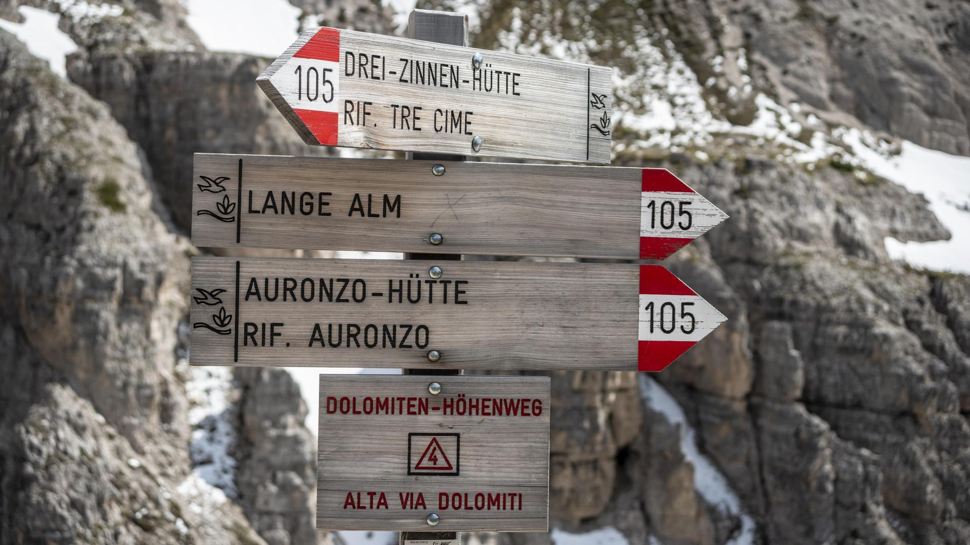 Wegweiser auf einem Wanderweg mit zweisprachiger Beschriftung auf Deutsch und Italienisch. Wegweiser auf einem Wanderweg mit zweisprachiger Beschriftung auf Deutsch und Italienisch.