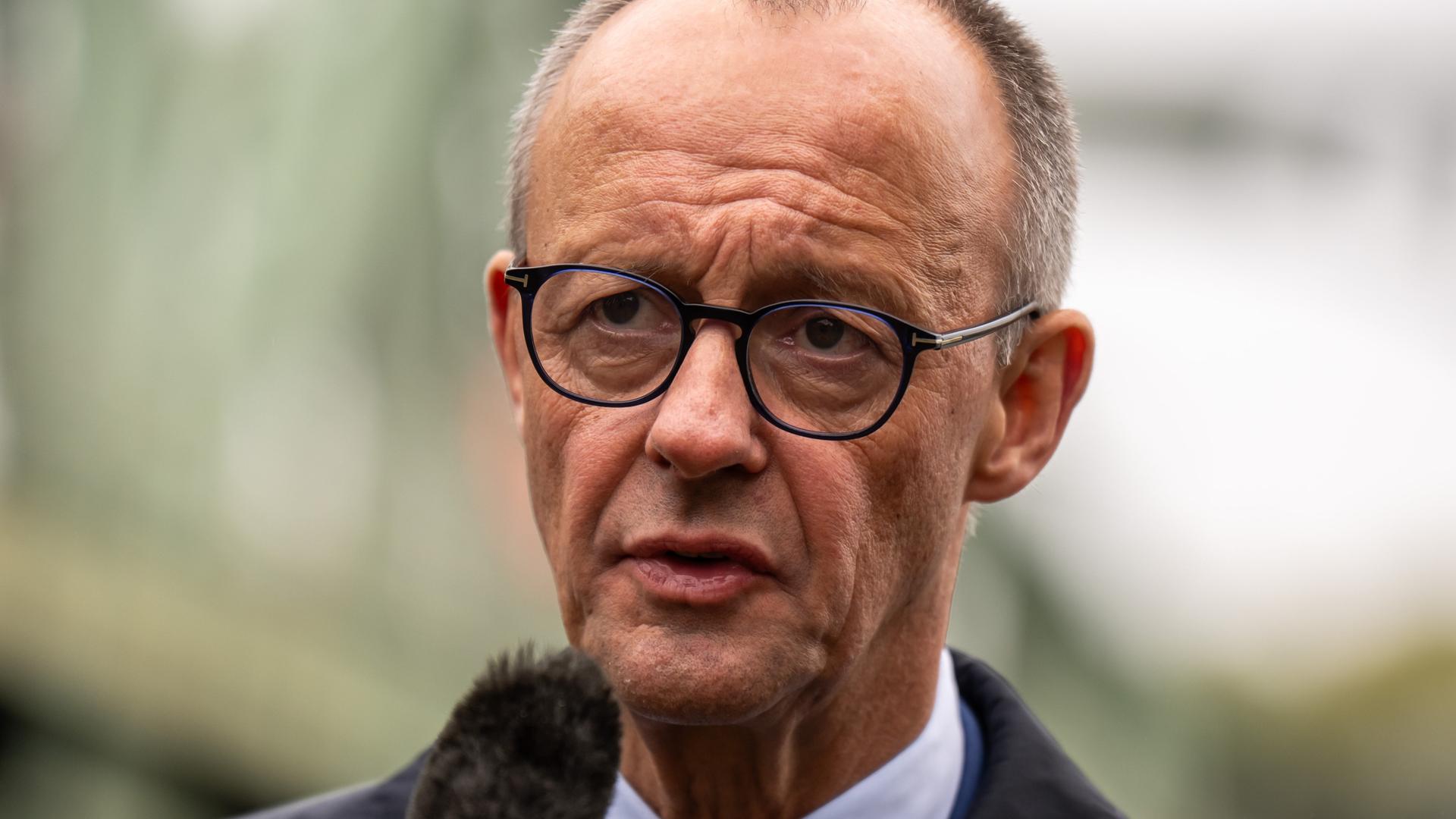 Bundeskanzler Friedrich Merz (CDU) steht vor der Glienicker Brücke beim Pressestatement nach seinem Antrittsbesuch in Brandenburg.