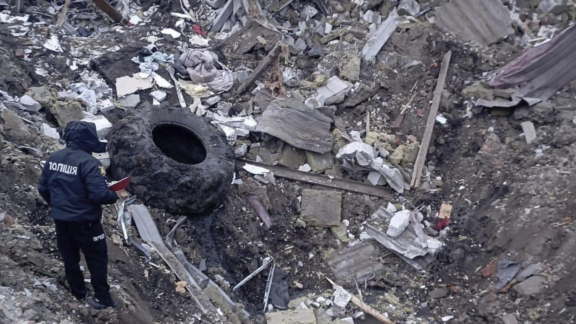 Ein Mensch steht vor den Trümmern eines nach einem Raketentreffer eingestürzten Hauses in Charkiw, Ukraine. Ein Mensch steht vor den Trümmern eines nach einem Raketentreffer eingestürzten Hauses in Charkiw, Ukraine.