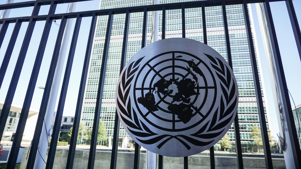 Ein Schild mit dem Logo der Vereinten Nationen vor dem UN-Hauptquartier in New York.  