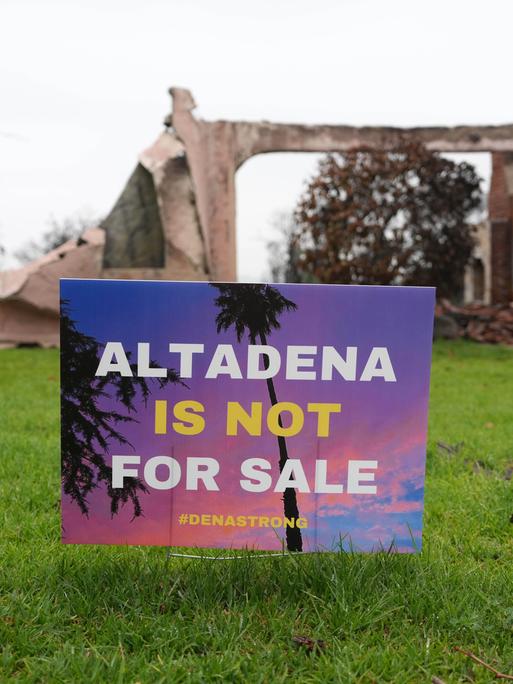 Im Garten vor der Ruine eines Wohnhauses steht ein Schild mit der Aufschrift "Altadena ist not for Sale".