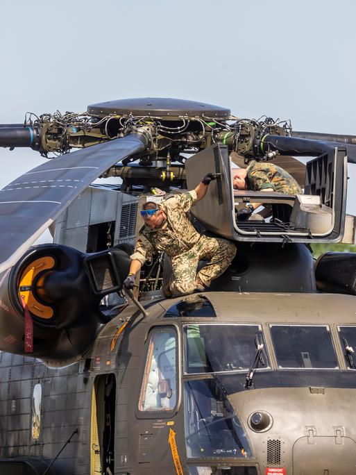Ein Militär-Hubschrauber wird am Motor repariert. 
