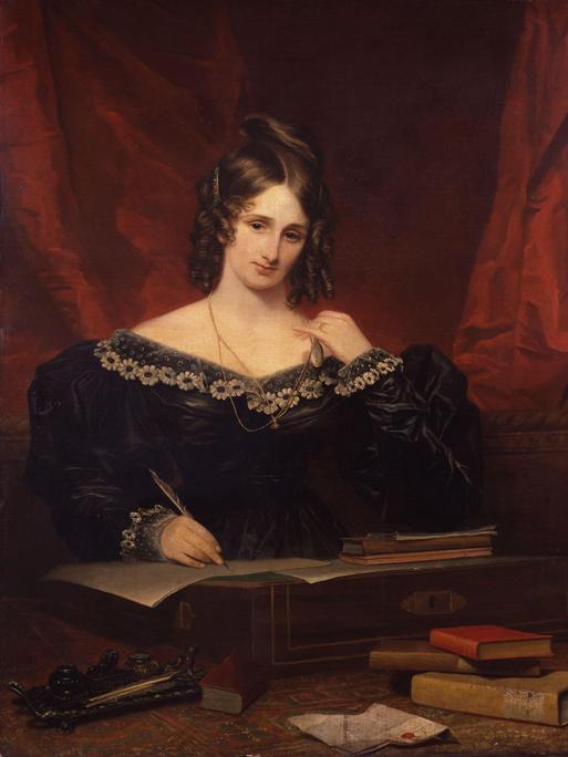 Ein Ölbild der Autorin Mary Shelley von 1831, gemalt von Samuel John Stump. Sie trägt ein schwarzes Kleid und die dunklen Haare streng zurückgenommen vor dunkelrotem Hintergrund.  