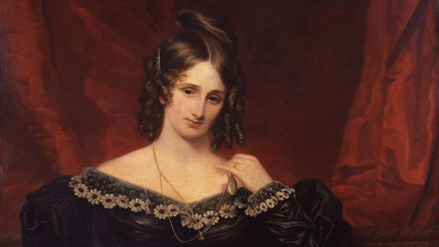 Ein Ölbild der Autorin Mary Shelley von 1831, gemalt von Samuel John Stump. Sie trägt ein schwarzes Kleid und die dunklen Haare streng zurückgenommen vor dunkelrotem Hintergrund.  