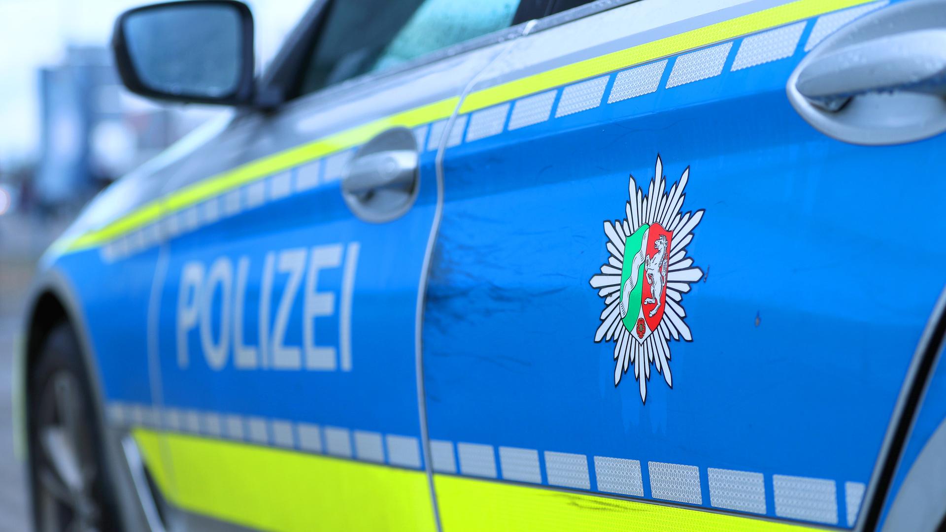 Schriftzug Polizei in Nahaufnahme und Wappen von Nordrhein Westfalen 