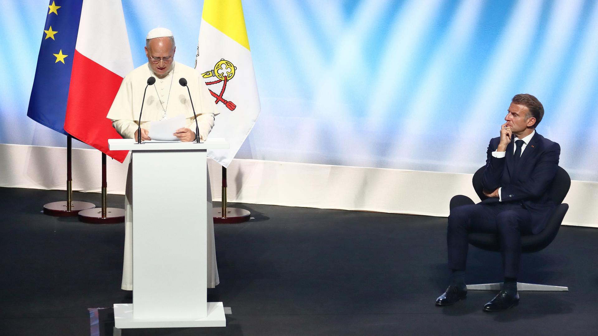 Papst Leo XIV bei einer Rede in Frankreich neben Präsident Macron