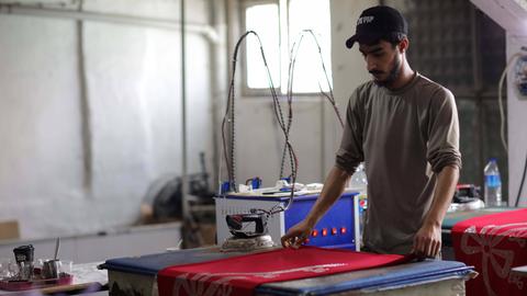 Eine Nähwerkstatt in der türkischen Stadt Gaziantep, die von Syrern gegründet wurde, die auf der Suche nach Sicherheit aus ihrem vom Krieg zerrütteten Land flohen. Einige junge syrische Kinder arbeiten auch mit ihren Vätern in der kleinen Fabrik, die hochwertige Kleidungsstücke und Coronavirus-Schutzkittel für den Export in den Irak und andere arabische Länder herstellt. Syrer haben sehr unter dem Konflikt, der Vertreibung und dem Kampf ums Überleben in einem anderen Land gelitten, wobei Kinder oft arbeiten müssen und die Schule verpassen, um zum Einkommen ihrer Familie beizutragen.