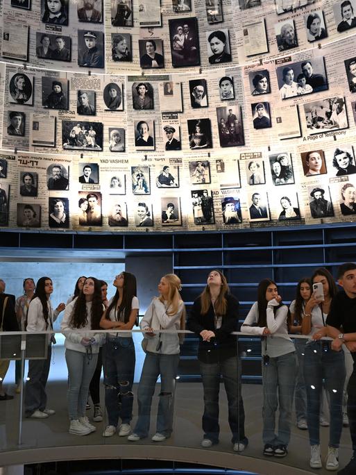 Besucher in Yad Vashem stehen unter einer Kuppel mit Fotos von NS-Opfern