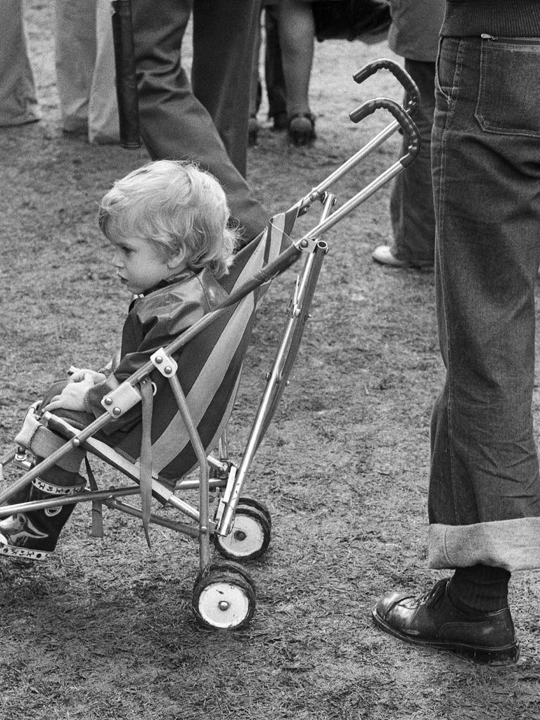 Ein Kind sitzt in einem Kinderwagen.