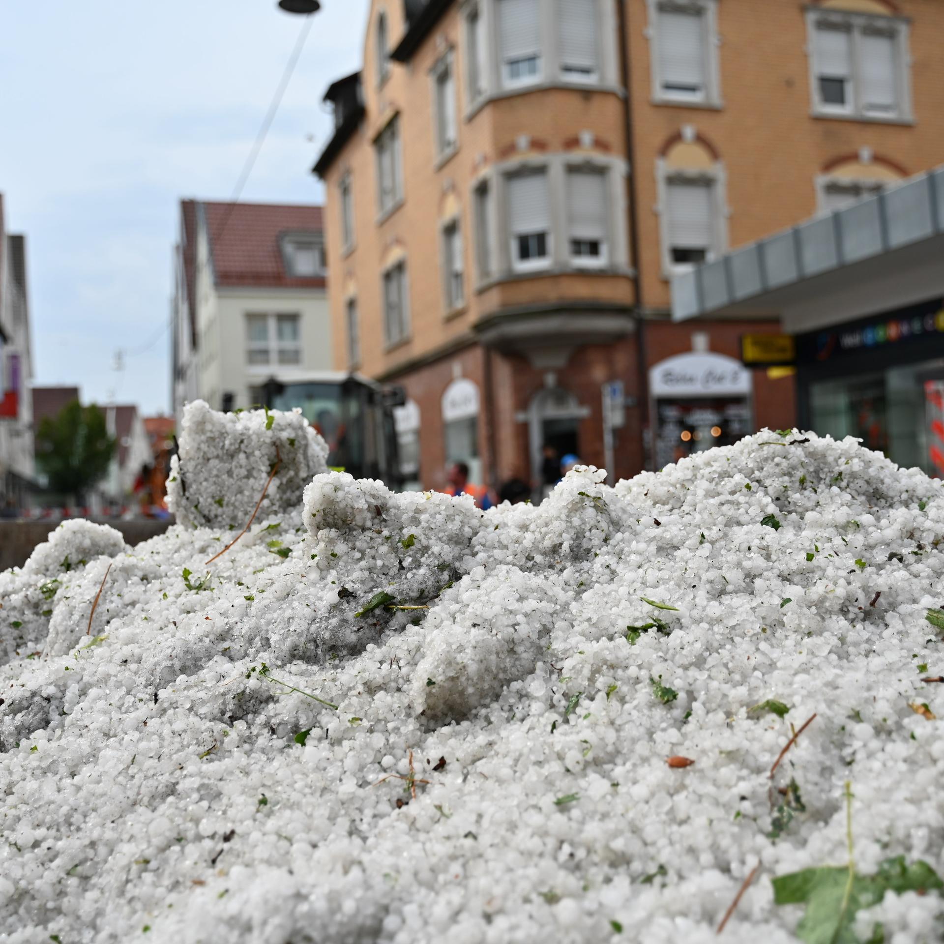 Baden-Württemberg, Reutlingen: Hagelkörner liegen nach einem Unwetter in einem Container in der Innenstadt. 