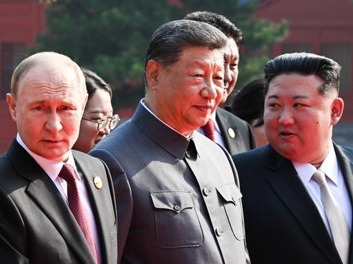 Xi Jinping (m) tritt mit Putin (l) und Kim Jong Un (r) an seiner Seite vor die Kameras.