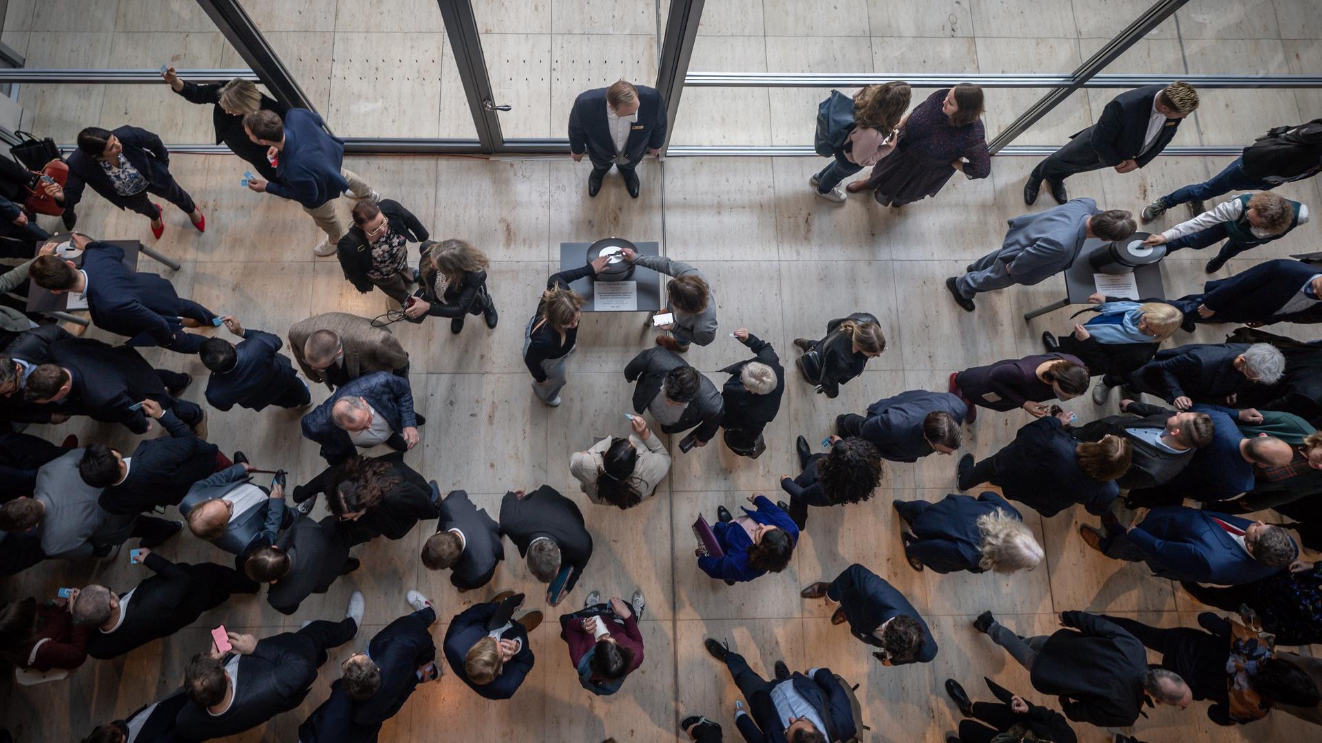 Abgeordnete werfen im Deutschen Bundestag ihre Stimmkarten ein. Abgeordnete werfen im Deutschen Bundestag ihre Stimmkarten ein.