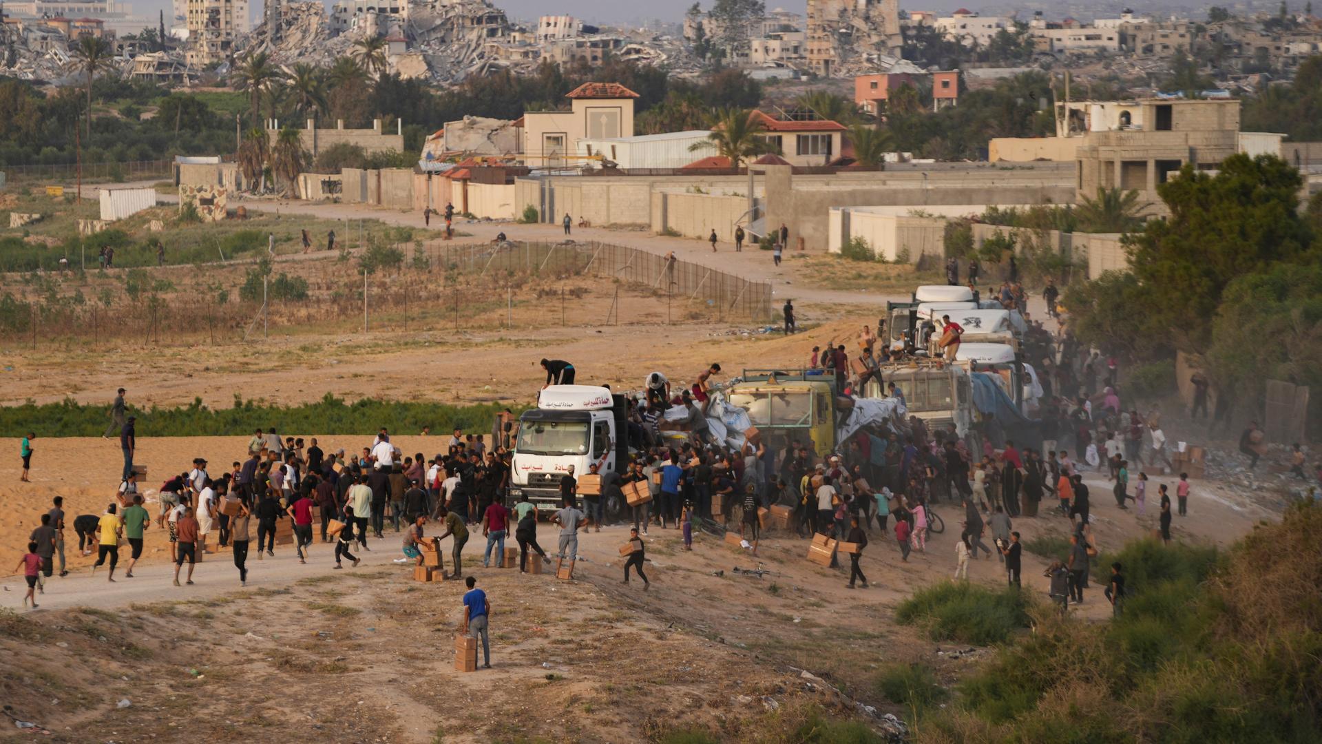 Palästinenser stürmen im Gazastreifen einen Lkw, der Nahrungsmittel und Wasser geladen hat.