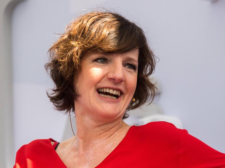 Die Autorin Doris Knecht wirft lachend den Kopf zur Seite.
