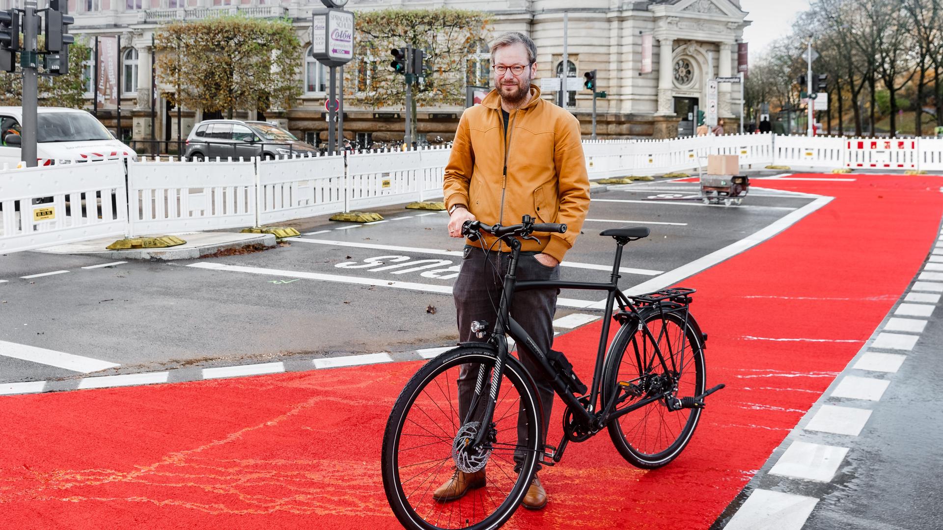 Anjes Tjarks (Bündnis 90/Grüne), Verkehrssenator Hamburgs, steht mit seinem Rad auf einer neu eingerichteten Fahrradspur auf der Esplande.