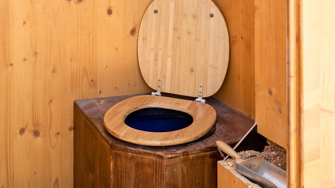 Eine WC-Komposttoilette, auch Trockentoilette genannt,  mit einer Holzumrahmung