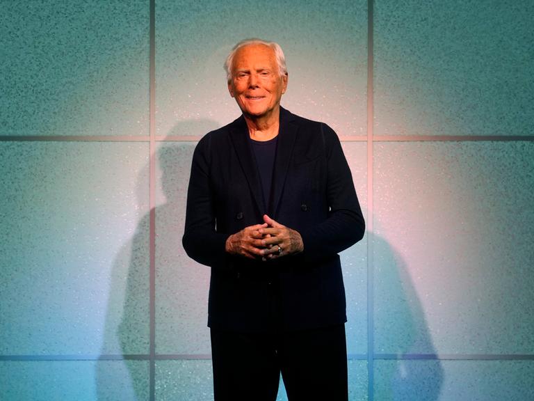 Designer Giorgio Armani accepts applause after the conclusion of his women's Fall-Winter 2024-25 collection presented in Milan, Italy, Sunday, Feb. 25, 2024. (AP Photo/Luca Bruno)
