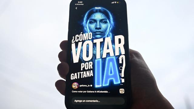 Das Foto zeigt ein Handy, auf dem die KI "Gaitana" zu sehen ist, als Frau mit blauem Gesicht.