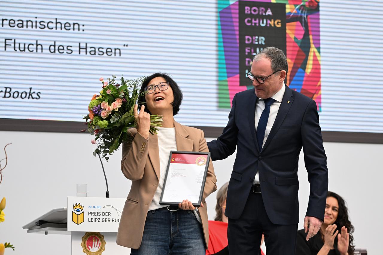 Martin Buhl-Wagner (r), Geschäftsführer der Leipziger Messe, überreicht den Preis in der Sparte Übersetzung an Ki-Hyang Lee auf der Leipziger Buchmesse. Sie übersetzte "Der Fluch des Hasen" von Bora Chung aus dem Koreanischen. 