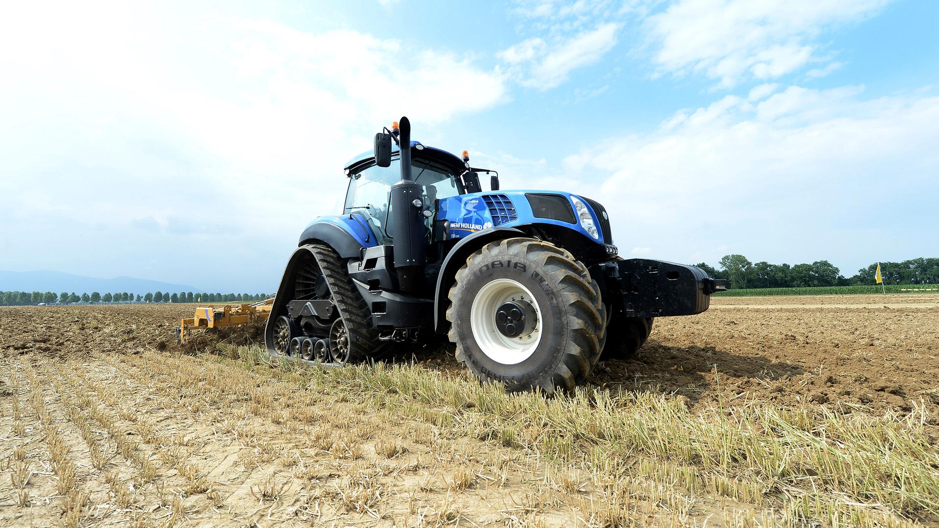 In this photo taken on June 10, 2015, a moment of the presentation and live demonstration to introduce the New Holland T6 Methane Tractor in Turin, Italy. The new technology is being developed to respond to the future needs of the agriculture industry, with the goal of making farms self-sufficient and sustainable. (AP Photo/Massimo Pinca)