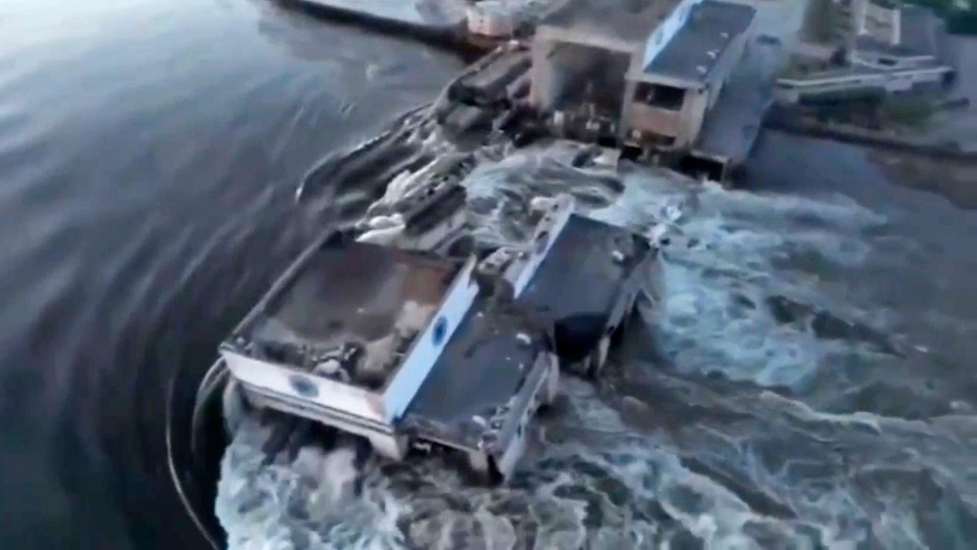 Dieses vom ukrainischen Präsidialamt veröffentlichte Foto zeigt, wie Wasser durch den in Teilen zerstörten Kachowka-Staudamm fließt.