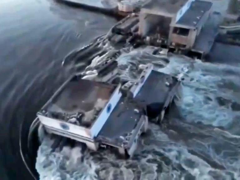 Ukraine, Kachowka: Dieses vom ukrainischen Präsidialamt über AP veröffentlichte Videostandbild zeigt Wasser, das durch einen Durchbruch im Kachowka-Staudamm fließt. Im von Russland besetzten Teil der südukrainischen Region Cherson ist nach Angaben der Kriegsparteien ein wichtiger Staudamm nahe der Front schwer beschädigt worden. 
